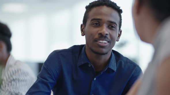 Smiling African Man Chatting with Colleagues