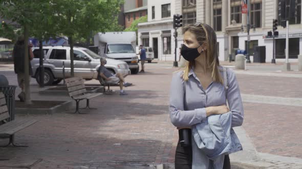 Concept health and safety, woman wearing protective mask walking outside, virus protection