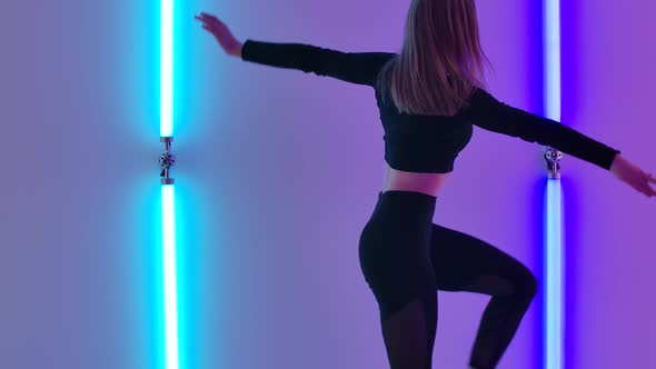 Young Dancer Demonstrates Sensual Movements By Dancing Contemp Against Backdrop of Bright Neon