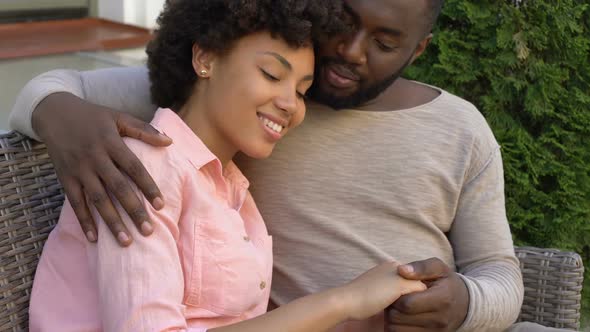 Happy African Couple Hugging on Bench, Outdoor Date in City Cafe, Closeness