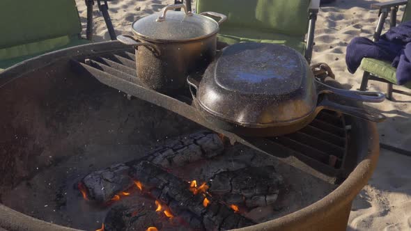 Pots cooking over campfire in extreme slow motion