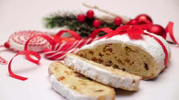 Sliced Traditional Christmas Stollen Cake with Marzipan and Dried Fruit Isolated on White Background