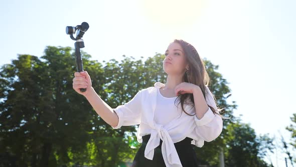 Woman Recording Video Blog On Camera On Street