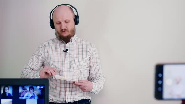 A Bald Man with a Beard Conducts Training Online Studying Alphabet