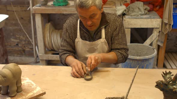 Potter working on pottery shop