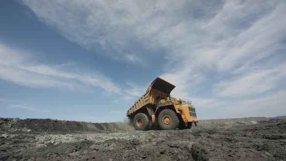 Multiton Dump Truck Lifts Body Unloads Waste Rock and Leaves