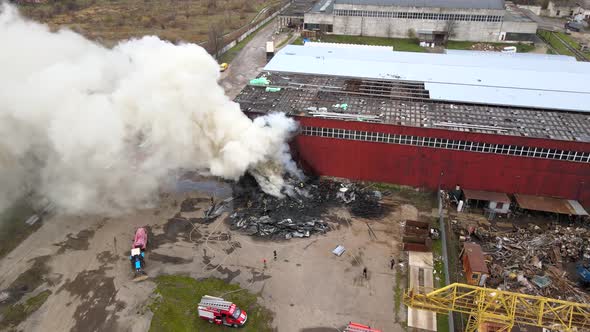 Aerial View of Firemen Fighting with Fire Near Old Factory Biulding in Industrial Area