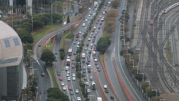 Aerial View of Traffic on the Roads and Railways of Barcelona Cars and Motorcycles in Movement