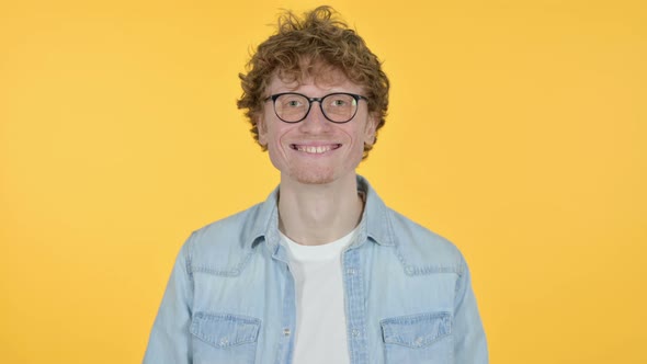 Smiling Redhead Young Man, Yellow Background 