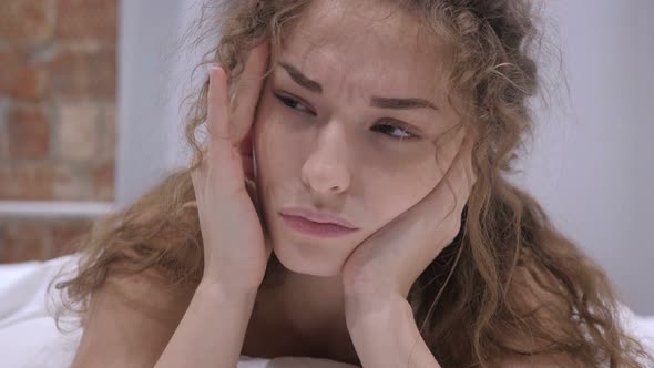 Woman with Stress and Headache Lying in Bed