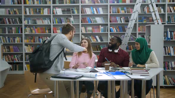 Multi Ethnic College Students Meeting in Library