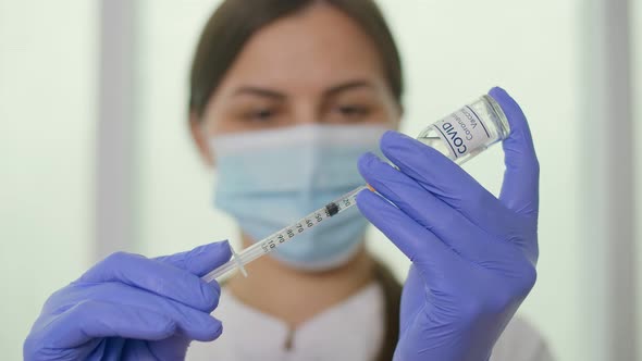 Closeup A Vial of the COVID19 Coronavirus Vaccine is Being Used By a Scientist