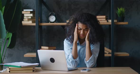 Stressed Young Woman Business Woman Suffering From Overwork Headache From Working at the Computer