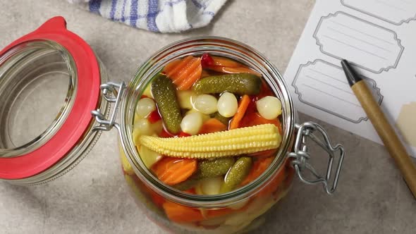Glass jar with fresh made pickled vegetable mix close up 