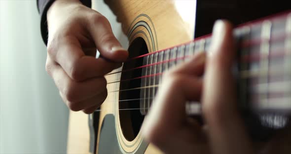 Playing the Guitar Strumming Acoustic Guitar Man Hand with a Guitar Neck