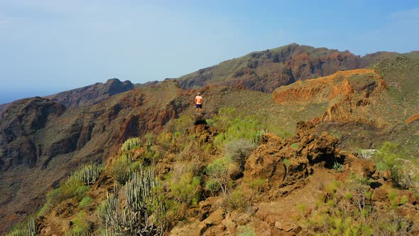 Man Traveler Enjoys Nature Landscape in Hike to Gorge