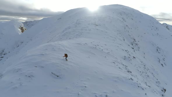 Mountain Climber on the Final Ascent of a Snowy Mountain