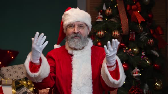 Portrait of Santa Claus Looking at the Camera and Congratulating Everyone on the Holidays