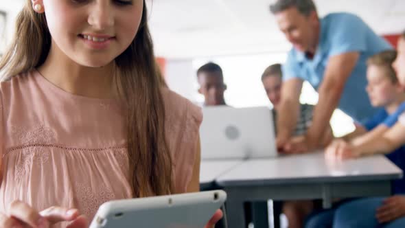 Portrait of happy schoolgirl using digital tablet