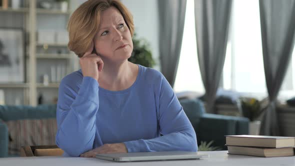 Portrait of Thinking Old Senior Woman in Office