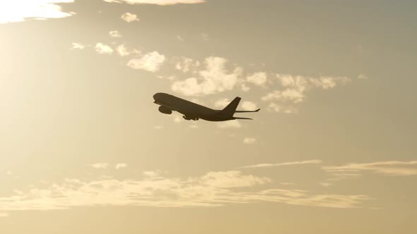  - Airplane Flying at Sunset