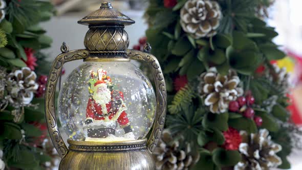 Beautiful snowglobe with Santa Clauss on Christmas background. Flat plane