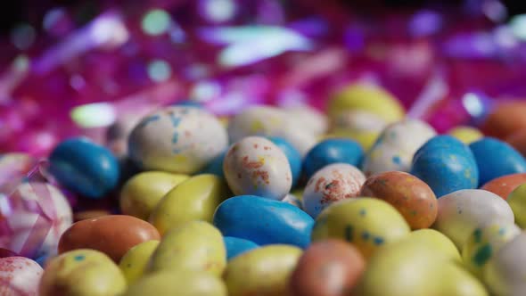 Rotating shot of colorful Easter candies on a bed of easter grass - EASTER 