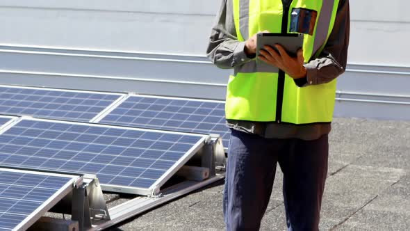 Male worker using digital tablet at solar station 4k