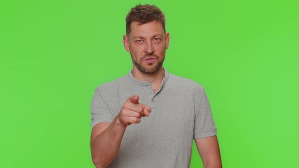 Handsome Young Man Pointing to Camera and Looking with Playful Happy Expression Making Choice