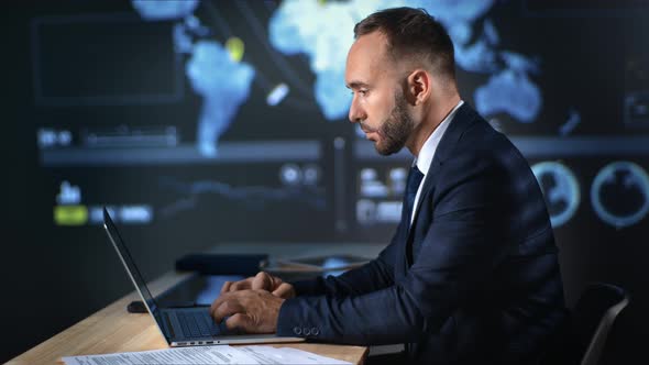 Focused Business Man Working on Laptop Pc Analyzing Profit Internet at Global Map Hi Tech Office