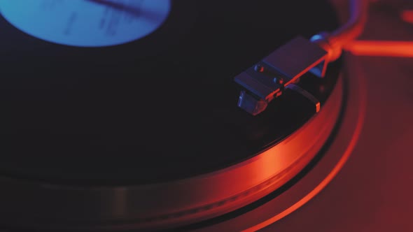 A Vinyl Record Spins in the Gramophone Music Player and Plays an Old Disco