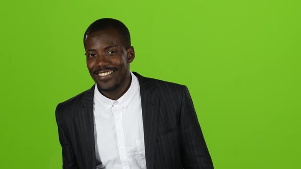 Businessman of an African American in a Suit Winks and Flirts. Green Screen