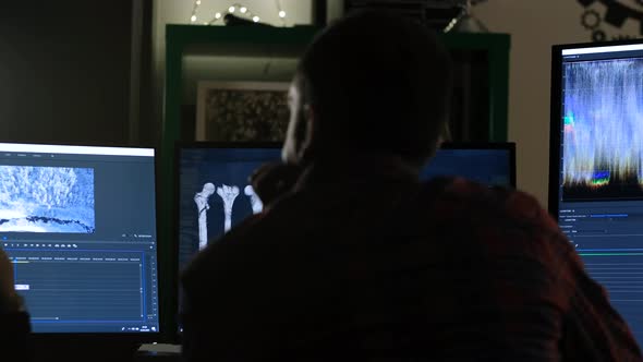 Man Editing Video on Computer