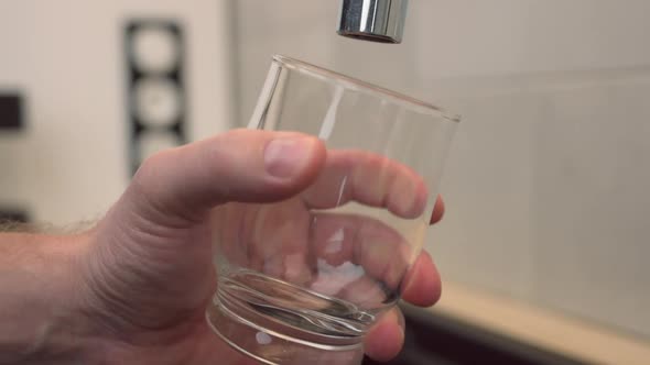 Man Pours Glass of Water