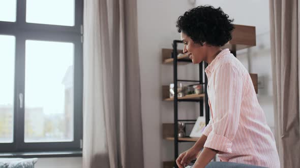 Woman Arranging Cushions at Home