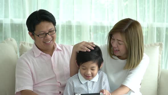 Asian Family Using Tablet At Home