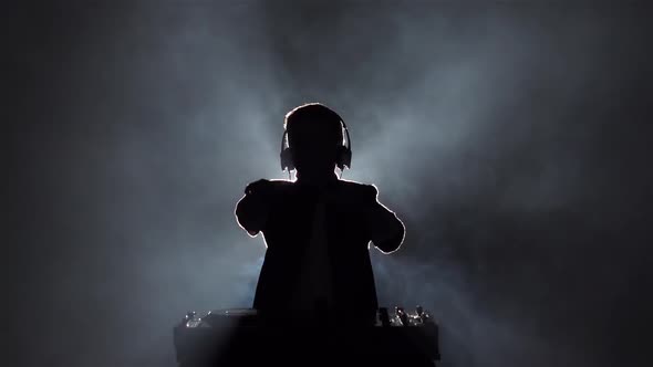 Silhouette Boy Dance and Plays Music on Vinyls. Slow Motion