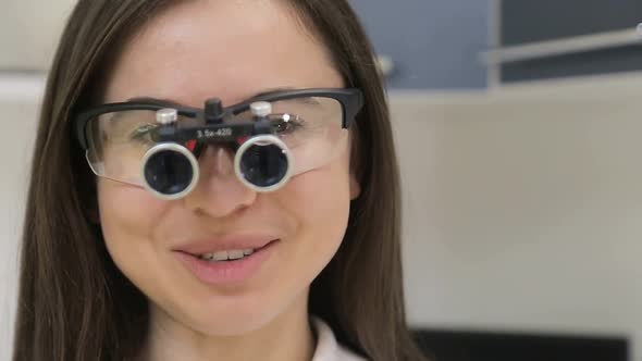 Young girl dentist applies new technology, cold teeth whitening