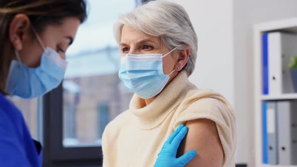 Nurse Applying Medical Patch to Vaccinated Woman