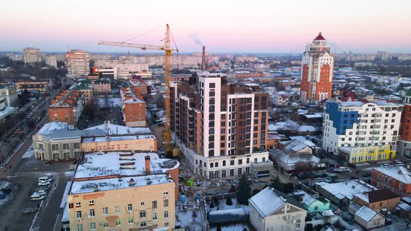 Aerial View of Drone Flying Over Building Construction in Small European City in Winter Cloudy Day