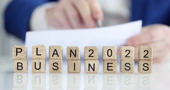 Businessman Makes a Business Plan for 2022 Closeup