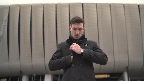 Businessman arranging his coat