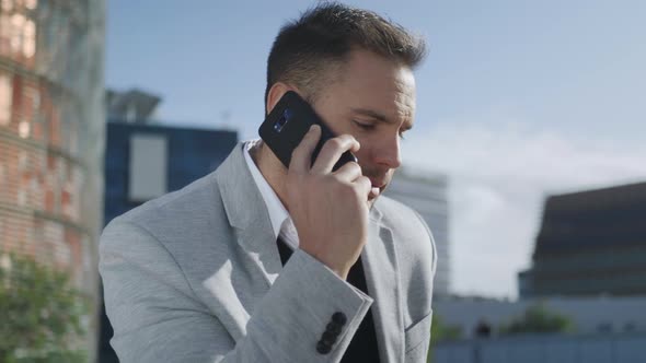 Businessman Having Phone Conversation at Street. Executive Talking on Smartphone