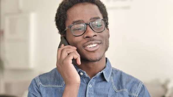 African Man Talking on Phone