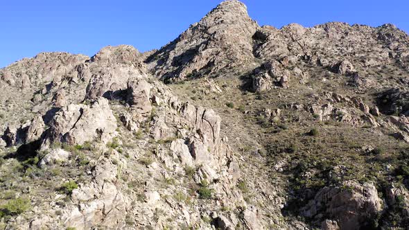 Coyote Mountains ridge and wilderness, Arizona. Slow Aerial climb showing sharp edge rocks and Sagua