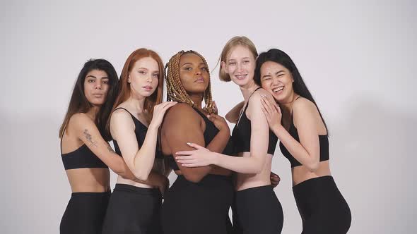 Fulllength Portrait of Young Diverse Models Hugging Each Other