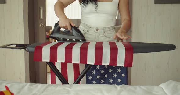 Patriotism Independence Day and Holidays Concept Young Woman Ironing the National American Flag at
