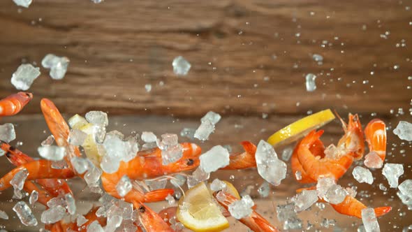 Super Slow Motion Shot of Flying Fresh Prawns with Crushed Ice and Lemon Slices at 1000 Fps.