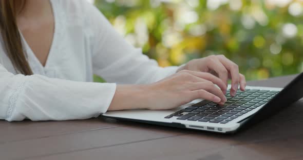 Woman work on notebook computer at outdoor cafe