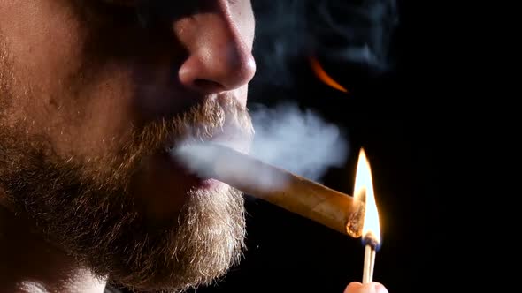 Man in a Dark Room, Smoking a Cigar